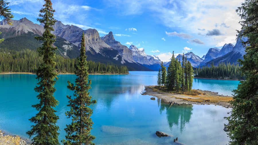 A Spectacular, Panoramic View Of A Mountain In The Mist, Surrounded By A Peaceful Lake Wallpaper