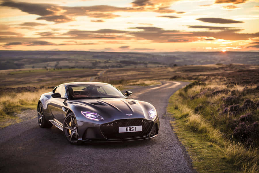 A Stunning Aston Martin V12 Vantage On The Open Road Wallpaper