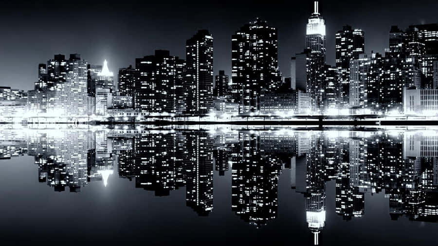 A Stunning Black And White Landscape Scene With A Winding Road Amidst The Majestic Mountains Wallpaper