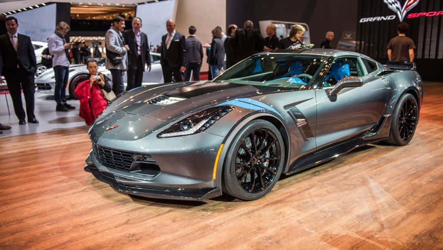A Stunning Chevrolet Corvette Grand Sport Parked Under The Sunlight Wallpaper