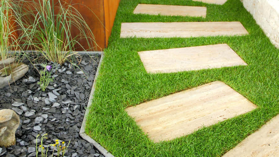 A Stunning Garden Design Featuring A Vibrant Combination Of Flowers And Greenery Wallpaper