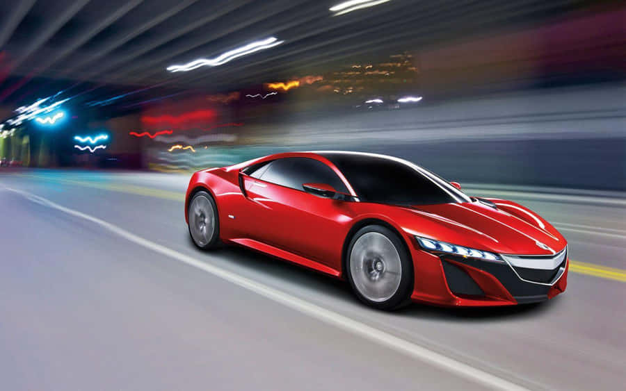 A Stunning Red Acura Nsx Showcased On An Open Road Wallpaper