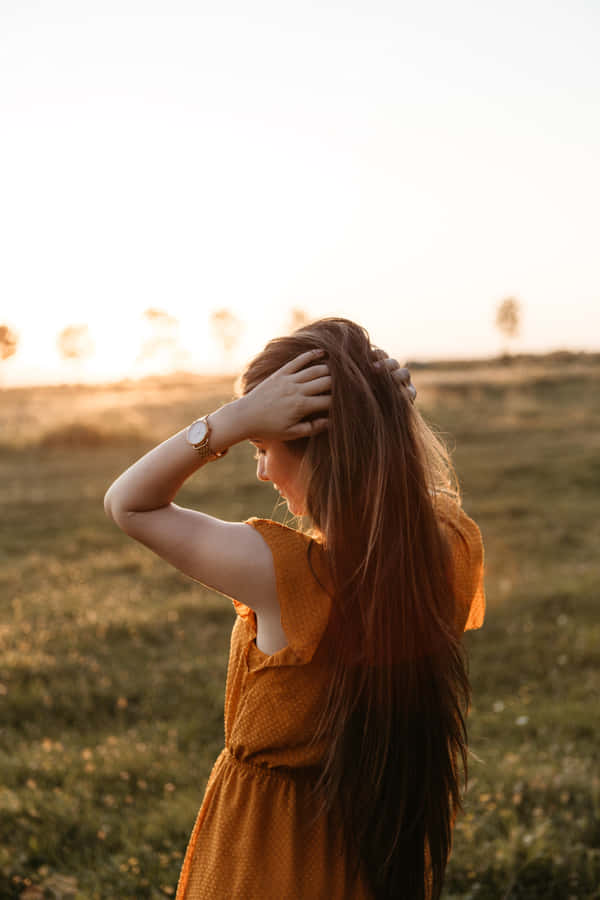 A Stunning Woman Enjoying A Beautiful Day Surrounded By Nature Wallpaper