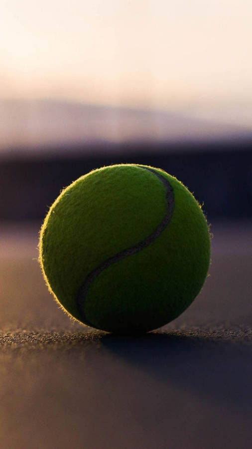 A Tennis Ball On A Tennis Court Wallpaper