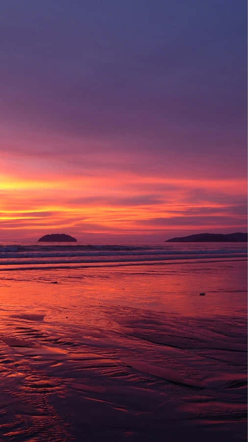 A Tranquil Sunset View Of The Beach On An Iphone Wallpaper