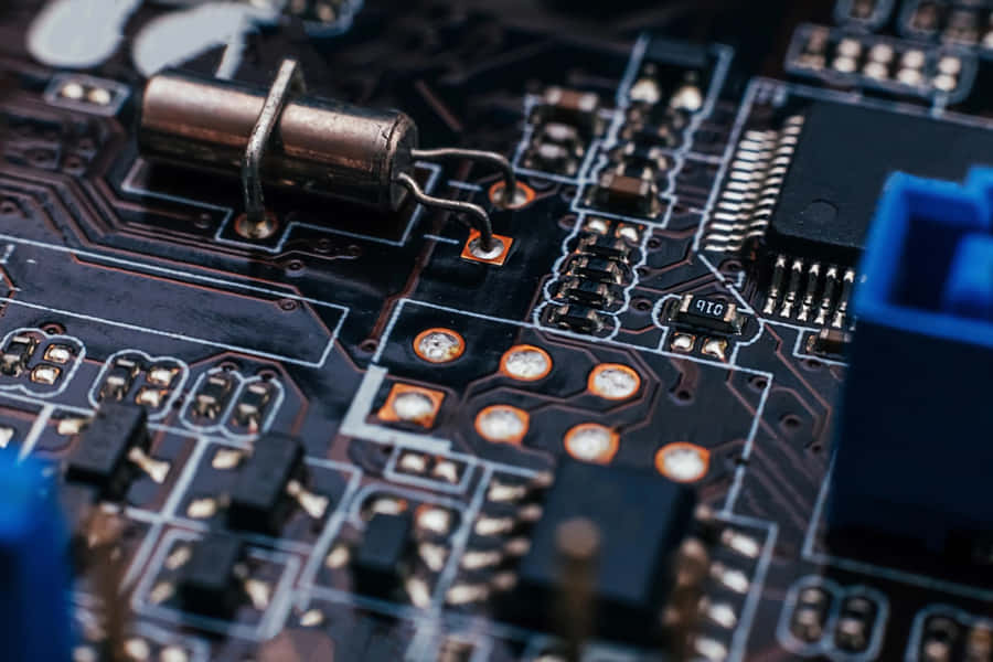 A Variety Of Electronic Components On A Green Circuit Board Wallpaper