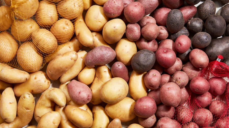 A Vibrant Pile Of Fresh Red Potatoes Wallpaper