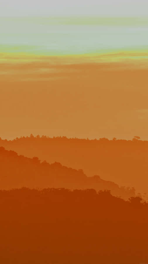 A Warm Light Orange Radiates A Calming Ambience. Wallpaper