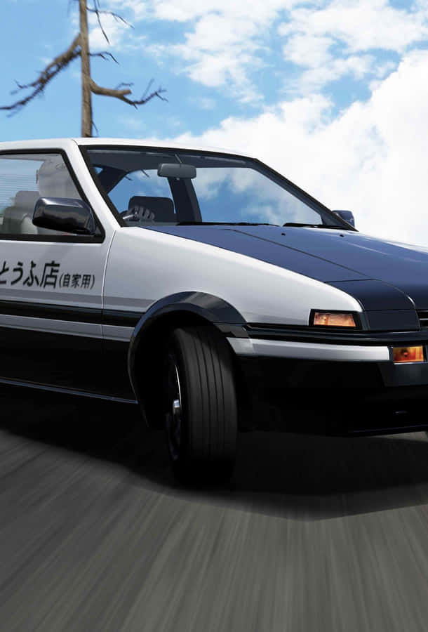 A White And Black Car Driving Down A Road Wallpaper