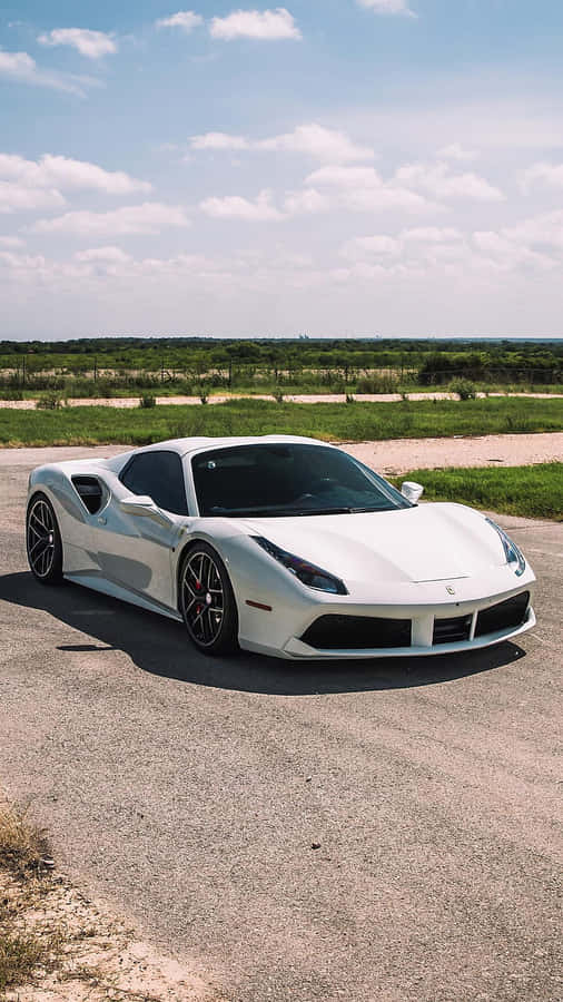 A White Ferrari Mobile Device Sitting Atop A Gray Background Wallpaper