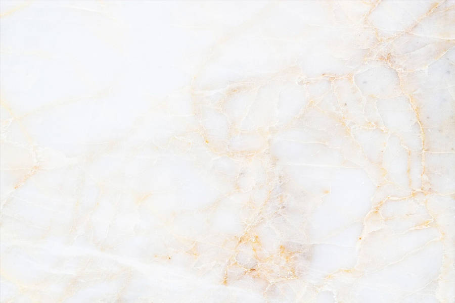 A White Marble Background With Gold And Yellow Wallpaper