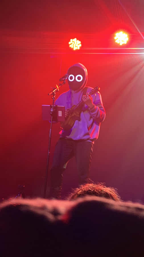 A Young Boy Plays An Unconventional Duo Instrument - A Ukulele And Violin Wallpaper