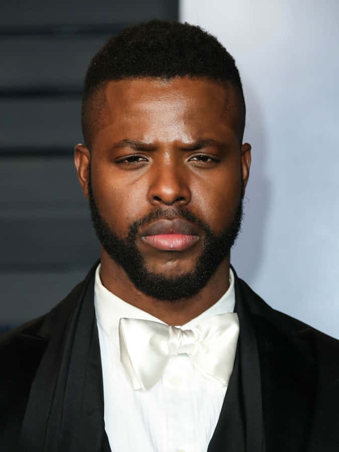 Actor Winston Duke Poses On A Red Carpet Wallpaper