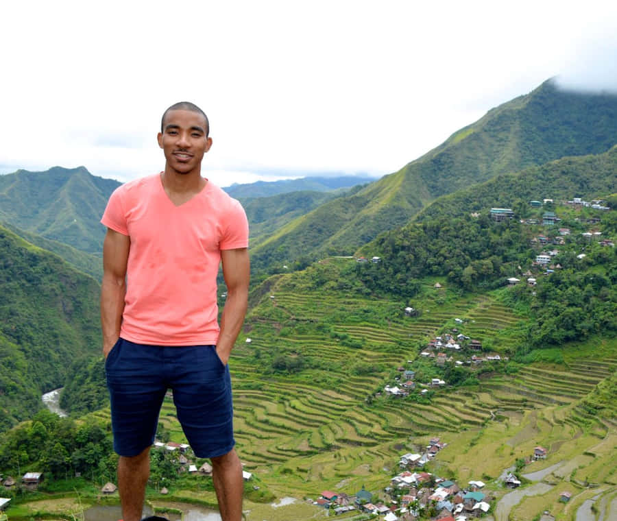 Adventurous Male Tourist Experiencing The Beauty Of Banaue Rice Terraces Wallpaper