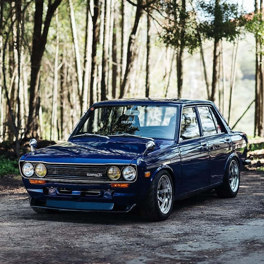 Aesthetic Profile Of Vintage Datsun 510 On Road Wallpaper