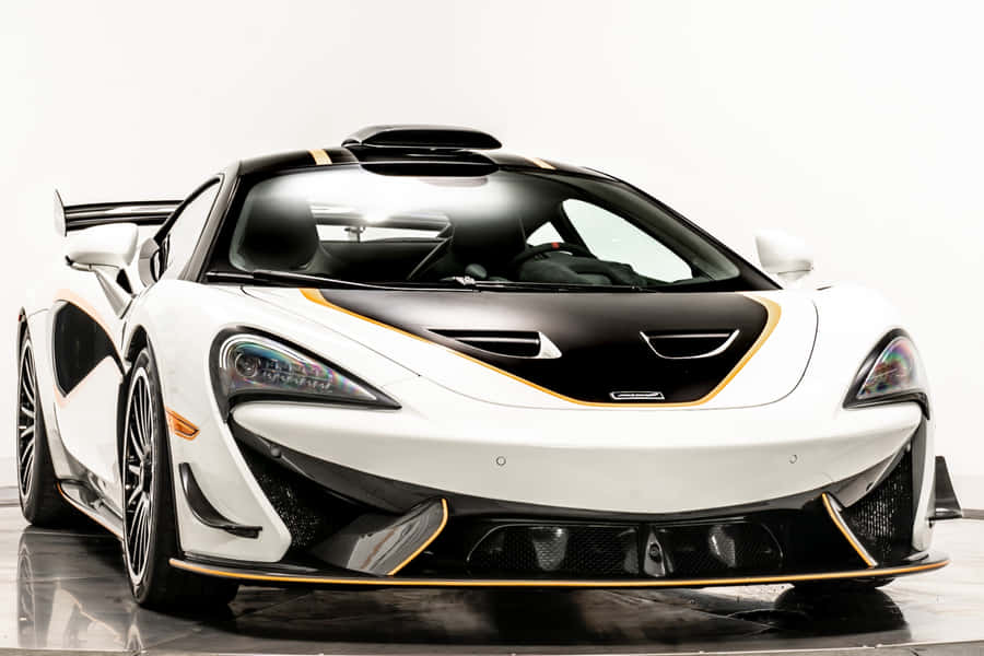 Aggressive And Stylish Mclaren 620r On The Road Wallpaper