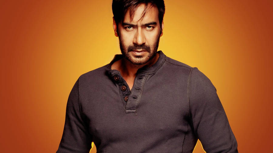 Ajay Devgn Fiery Orange Background Wallpaper