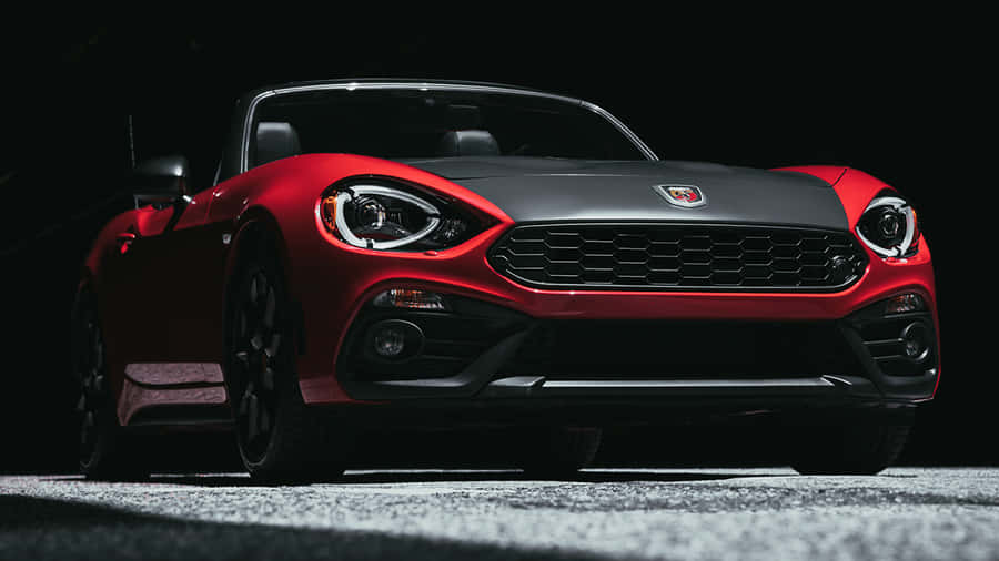 Alluring Fiat 124 Spider On Scenic Open Road Wallpaper