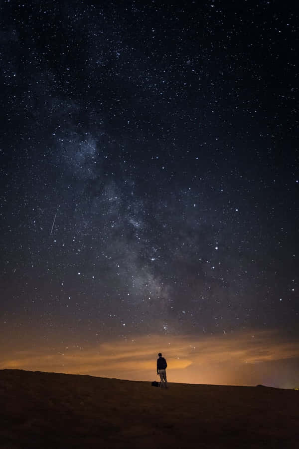Alone Man In A Dark Starry Night Wallpaper