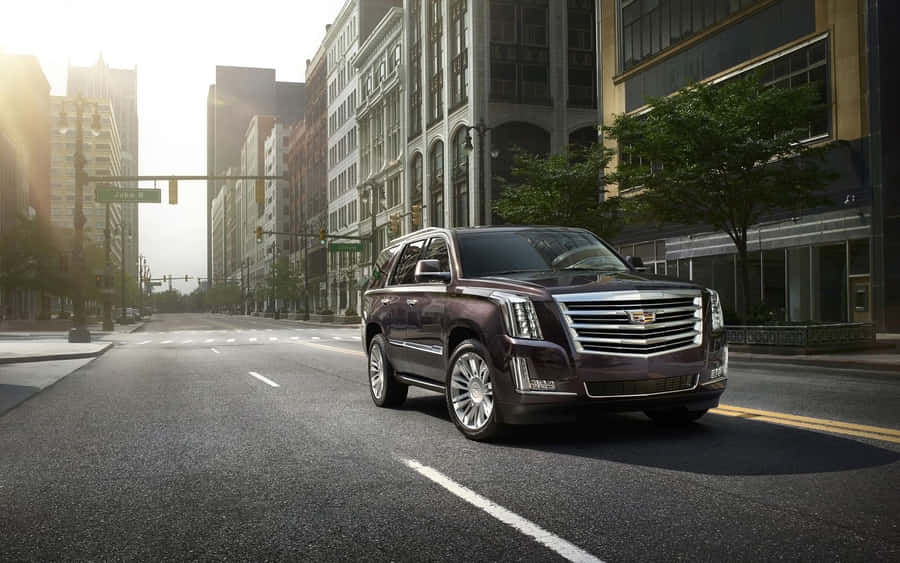 An Elegant Cadillac Escalade On The Road Wallpaper