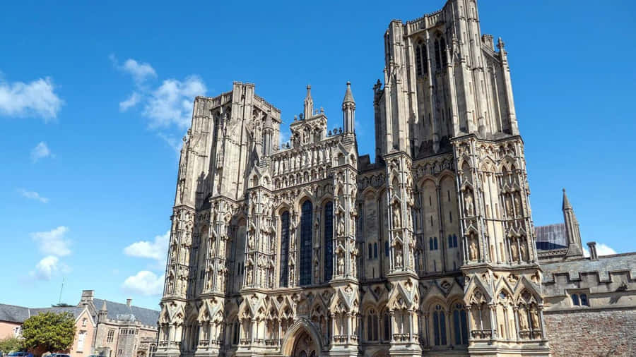 Ancient Wells Cathedral Against The Vibrant Sky In Wells, Uk Wallpaper