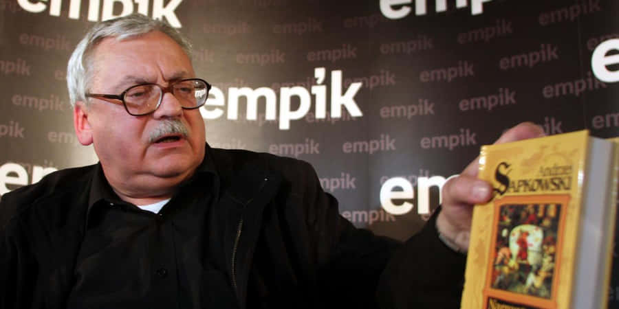 Andrzej Sapkowski Holding Book Wallpaper
