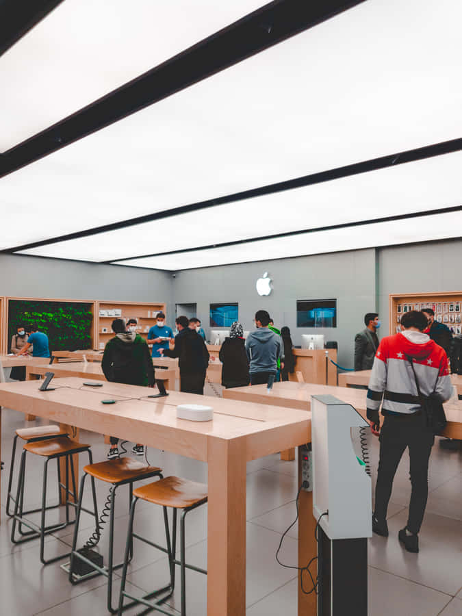 Apple Store Interiorwith Customersand Products Wallpaper