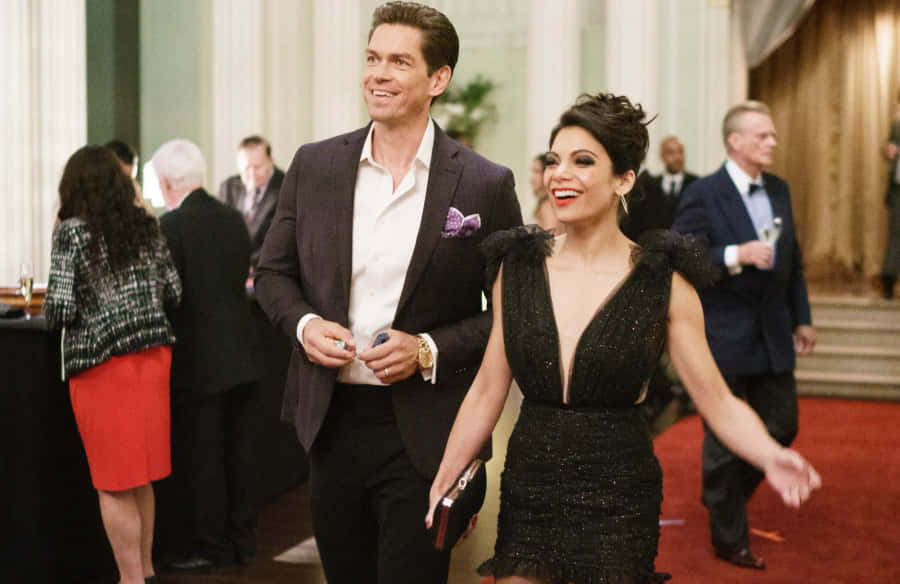 Arnold Schwarzenegger And Jamie Lee Curtis In A Thrilling Scene From True Lies Wallpaper