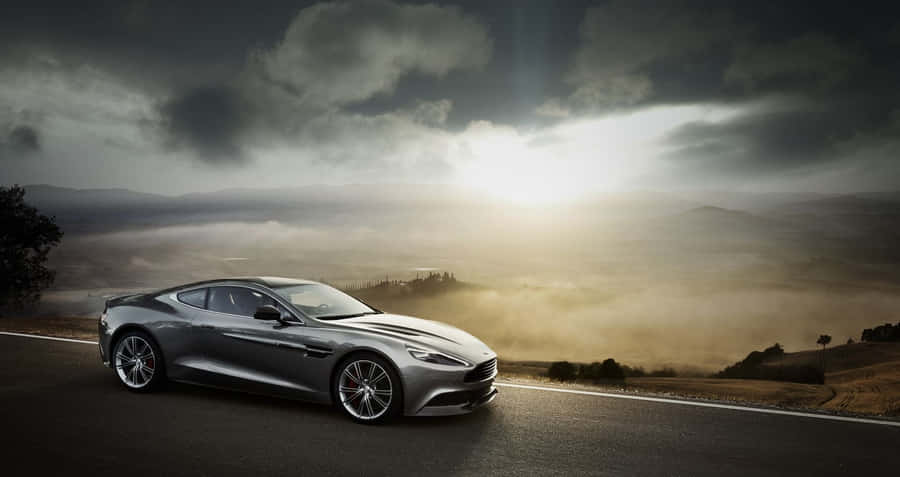 Aston Martin Db9 - Luxury Sports Car In Action Wallpaper