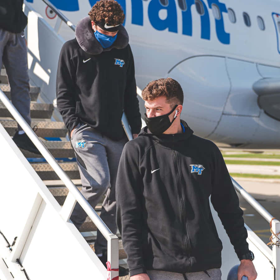 Athletes Disembarking Airplane Wallpaper