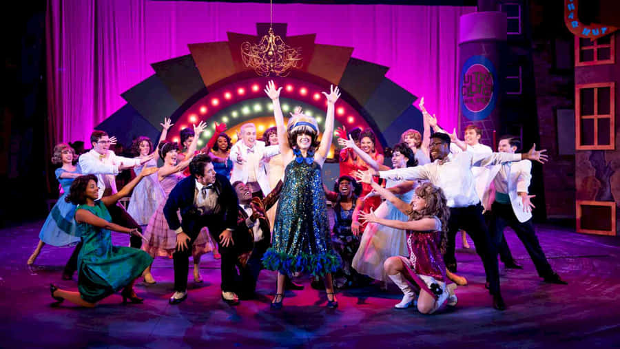 Audience Applauding A Spectacular Performance Of A Musical Wallpaper