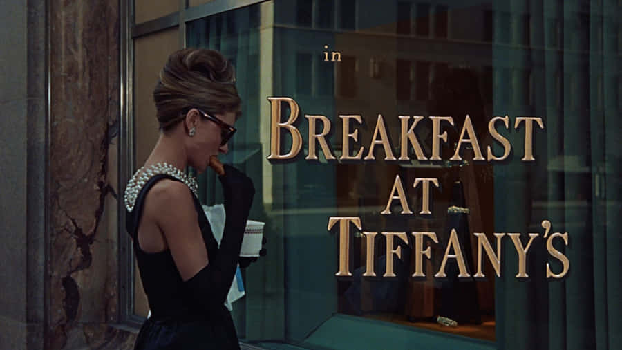 Audrey Hepburn Outside Of Tiffany's Jewelry Looking Beautiful In Her Signature Style Wallpaper