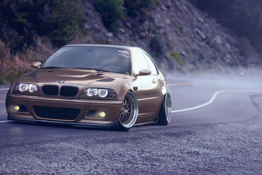 B M W E46 Golden Coupe Driftingon Mountain Road Wallpaper