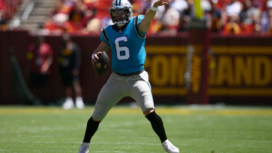 Baker Mayfield Throwing In The Field Wallpaper