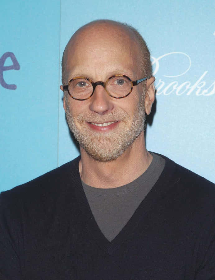 Bald Manwith Glassesat Event Wallpaper