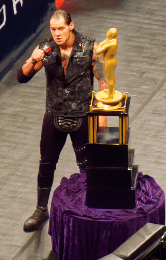 Baron Corbin Beside Andre The Giant Trophy Wallpaper