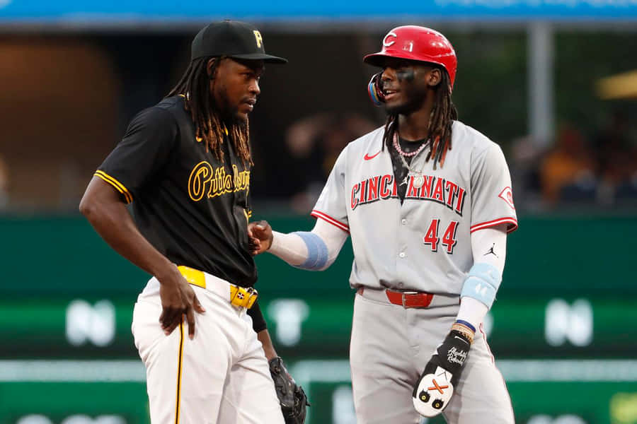 Baseball Players Friendly Exchange During Game Wallpaper