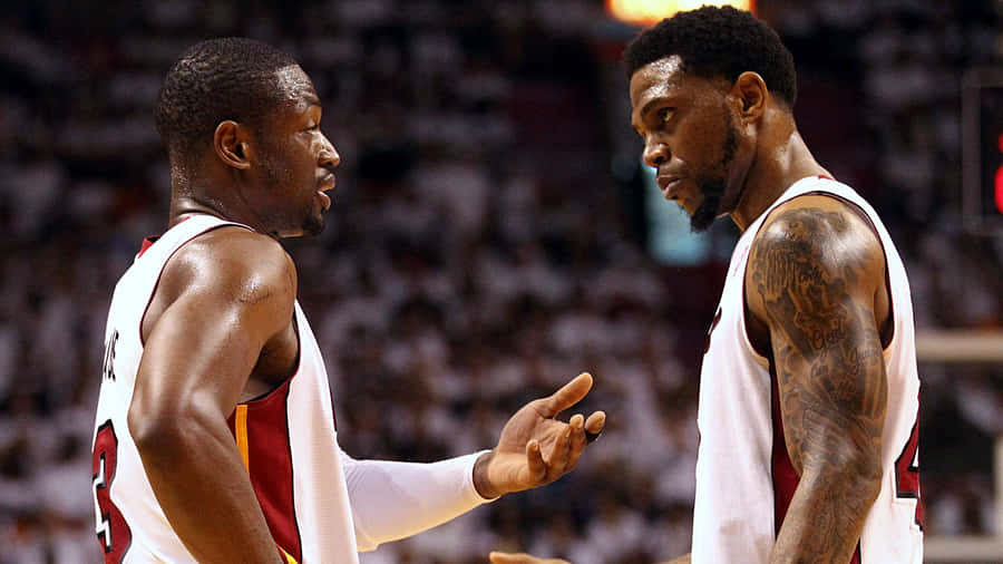 Basketball Players Strategic Discussion Wallpaper