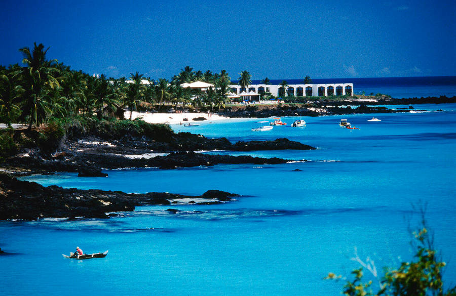 Beach In Comoros Surrounded By Rocks Wallpaper