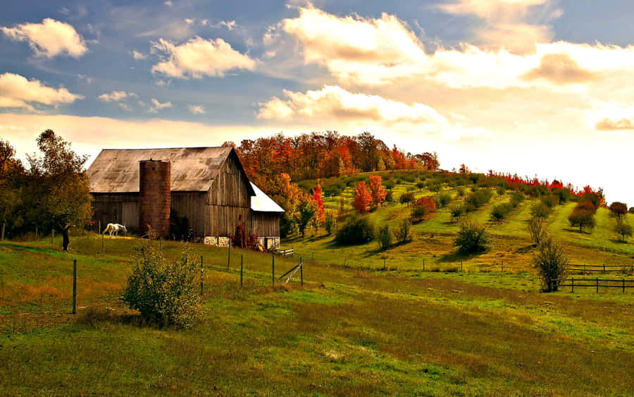 Beautiful Fall Barn Surrounded By Autumn Foliage Wallpaper