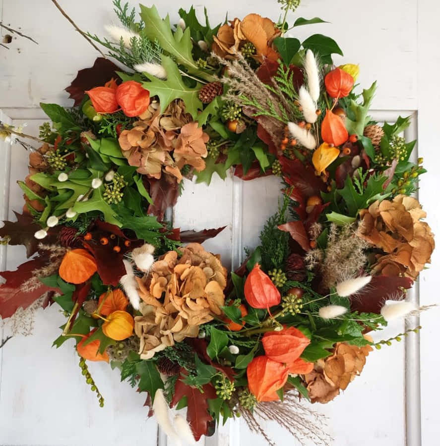 Beautiful Fall Wreath On Rustic Wooden Door Wallpaper