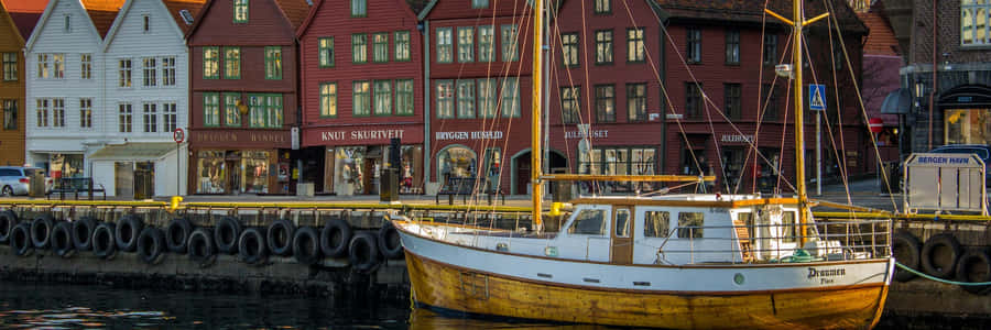 Bergen Bryggen Waterfrontwith Boat Wallpaper