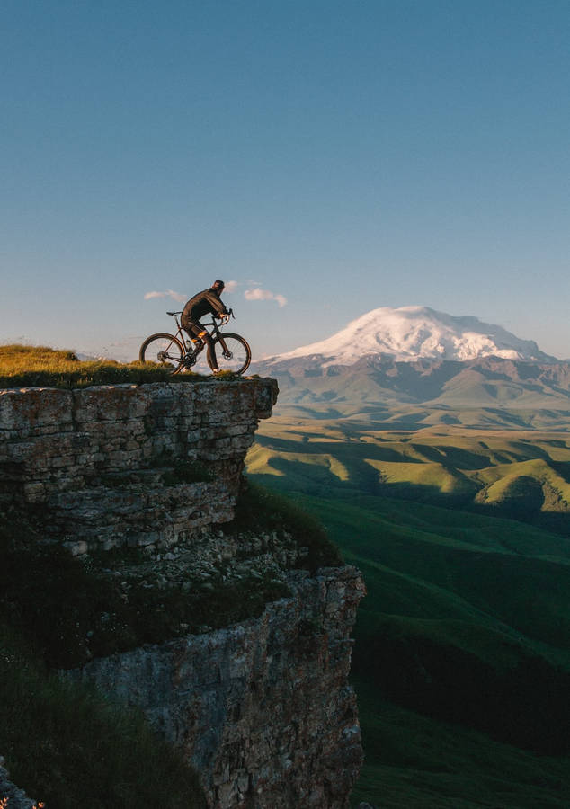 Bike Lover On A Cliff Wallpaper