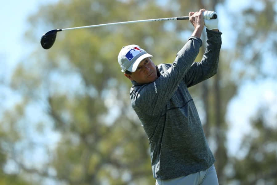 Billy Andrade Swinging A Golf Club Wallpaper