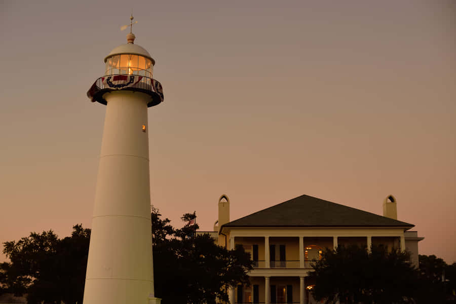 Biloxi Lighthouse In Mississippi As The Sun Sets Wallpaper