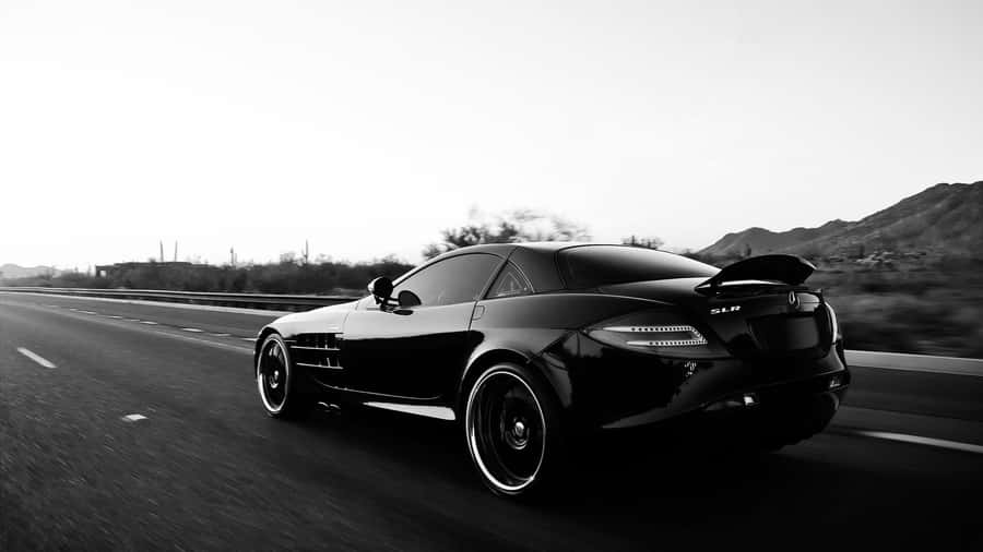 Black Sports Car Speedingon Highway Wallpaper