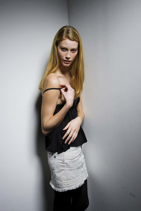 Blonde Modelin Black Topand White Skirt Wallpaper