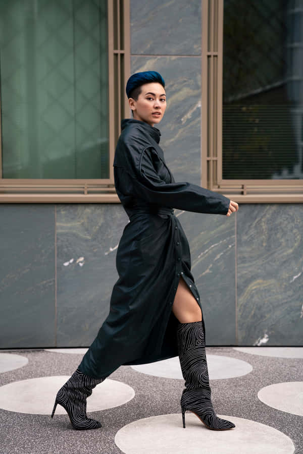 Blue Haired Womanin Black Coatand Boots Wallpaper