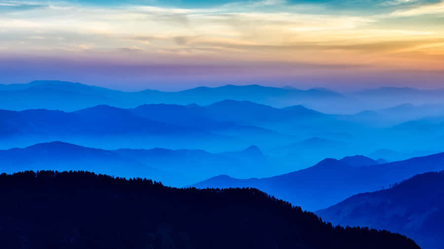 Blue Mountain Silhouettesat Sunset Wallpaper