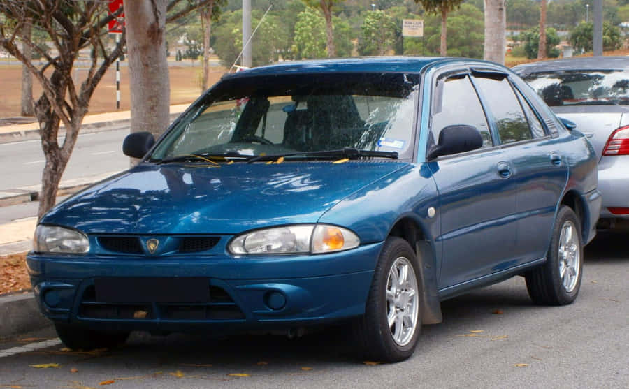 Blue Proton Wira Parked Outdoors Wallpaper